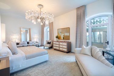 all-white bedroom with crystal chandelier