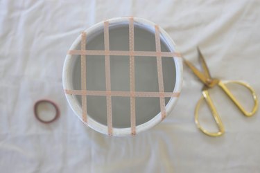 Floral vase filled with water with grid pattern taped on top