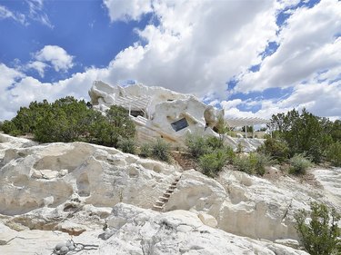 Rock house that blends in with the limestone cliffs it sits on.
