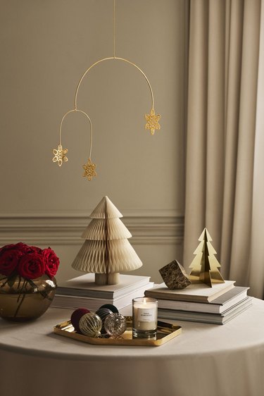 H&M holiday home decor with gold metal snowflake mobile