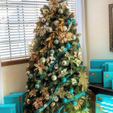 blue ribbon wrapped around a coastal Christmas tree