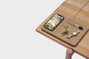 corner of light wood desk with CATCH:3 linen wireless charger and accessories