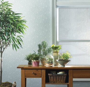 A desk with a window behind it covered in a ribbed window film