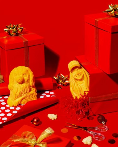 Whisps Personalized Cheese Carvings on red background with gifts nearby