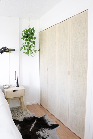 Boho bedroom with fabric paneled closet door.