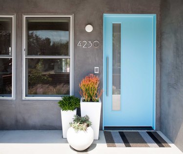 light gray stucco home with robin's egg blue door
