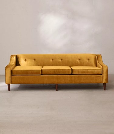 gold velvet sofa with buttons