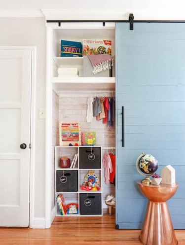 Nursery with blue barn door.