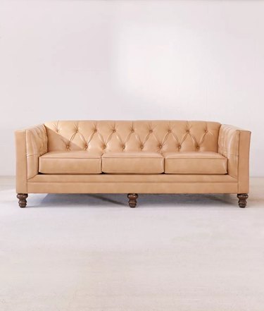 light leather couch with button tufting