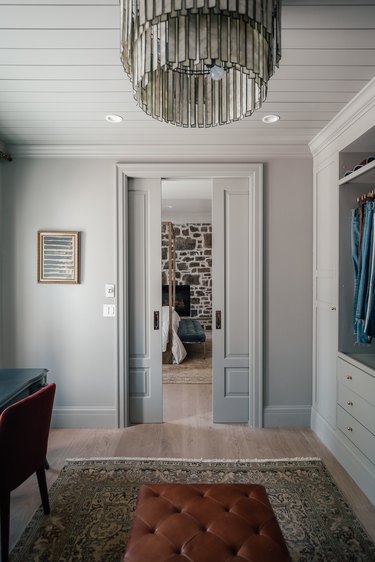 Bedroom with chandelier and pocket doors.