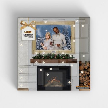 Martha Stewart and Snoop Dogg advent calendar with a fireplace on a white background.