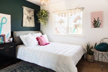 bedroom with brown floors and green walls