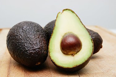 Cut avocado on a wooden cutting board