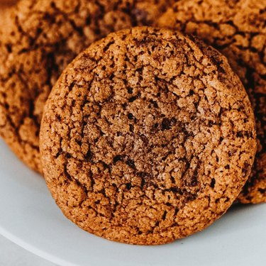A close up image of coffee cookies on a white plate.