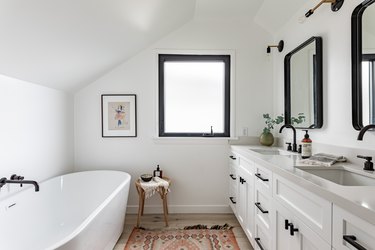 White bathroom with an oval shaped freestanding tub