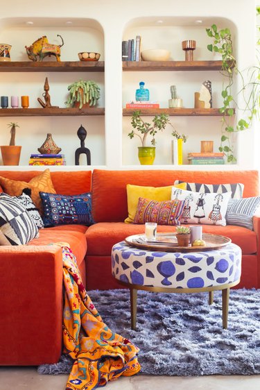 Orange and blue living room by Justina Blakeney