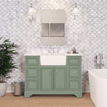 green farmhouse bathroom vanity with one apron sink