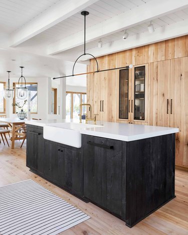 black wood and natural wood kitchen cabinetry in two-tone minimalist kitchen