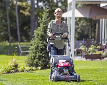 Homeowner Mowing Lawn With Honda Walk-Behind Lawn Mower w/ Electric Start