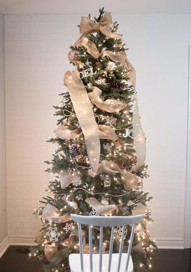 A Christmas tree with a ribbon garland