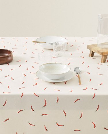 table with white dishes and chili-patterned design