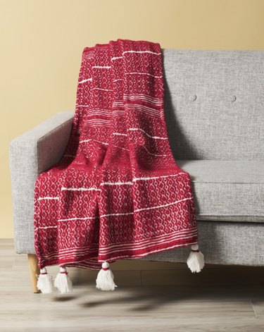 red and white blanket with tassels