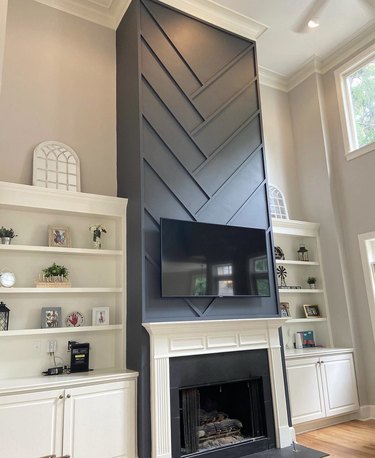 A fireplace with a slate blue construction made of trim pieces covering the chimney.