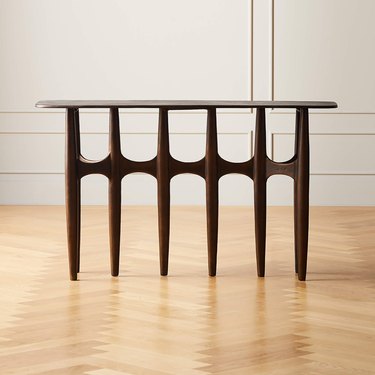 A brutalist console table featuring textured cast aluminum with dark bronze powdercoated finish.