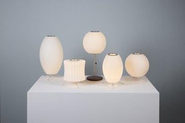 George Nelson bubble lamps lined up on a white table.