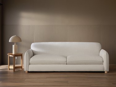A beige sofa inspired by the soft curves of California's coast, this unique sofa combines modern lines with a pillow soft appearance.