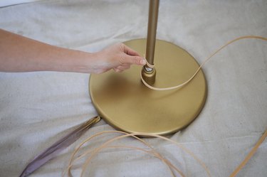 Wrapping flat reed around base of floor lamp