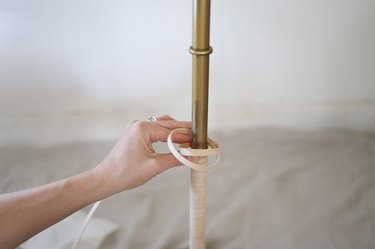 Wrapping flat reed around base of floor lamp
