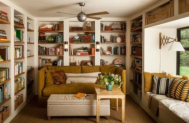 rustic library with floor to ceiling shelves and books