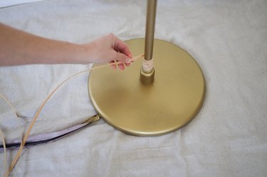 Wrapping flat reed around base of floor lamp