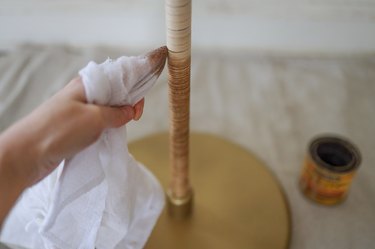 Wiping "Golden Oak" wood stain onto reed with a cloth