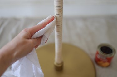 Wiping pre-stain wood conditioner onto reed with a cloth