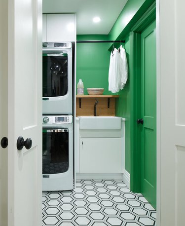 apple green laundry room with hex tile