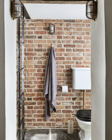 Industrial bathroom with exposed brick wall