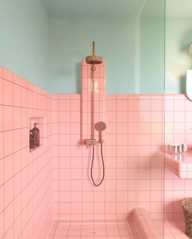 pink tiled bathroom with mint walls and brass shower fixture