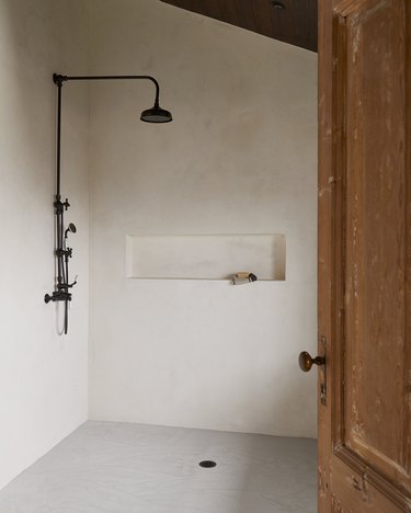 Industrial bathroom with plaster shower