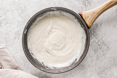 Simmer milk and spices to make béchamel sauce