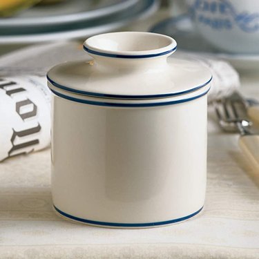 white ceramic butter bell with blue trim