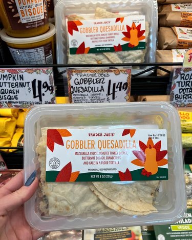 A hand holding the Gobbler Quesadilla from Trader Joe's.