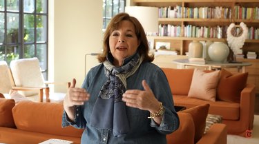 Ina Garten in a living room with orange couches.