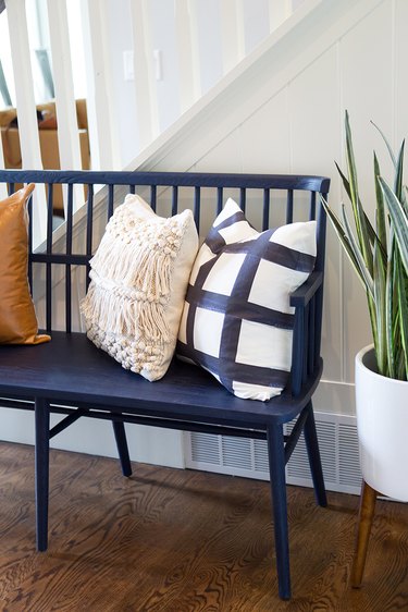 navy blue bench and throw pillows in entryway
