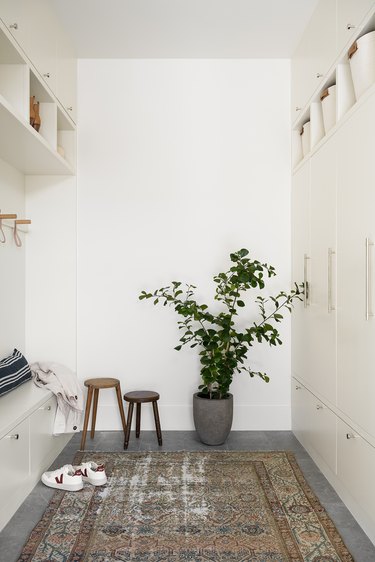 greige mudroom with wall to wall storage