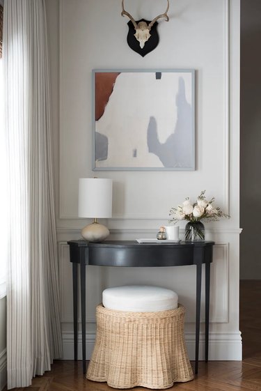 modern artwork and black table in entryway