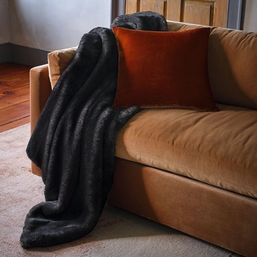 black blanket on brown couch
