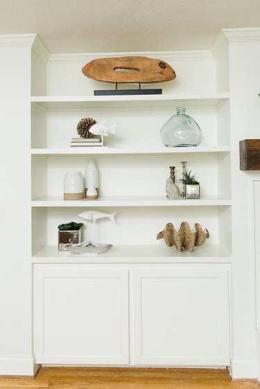 built-in shelves with decor in white living room