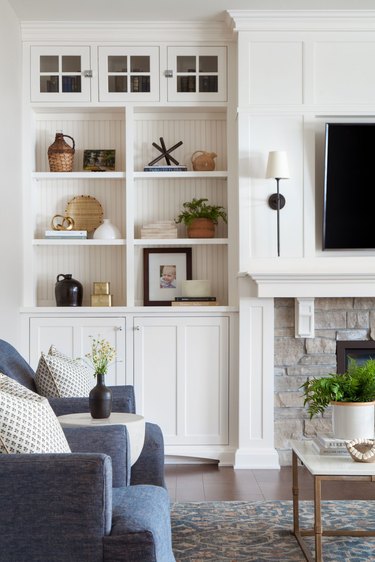white transitional living room with built-in shelving